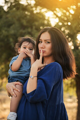 Fototapeta premium Mother Holding Her One Year Old Son in Nature