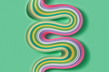 Twisted paper ribbons creating curves in green studio