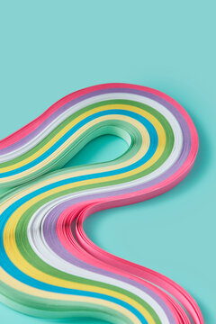 Paper stripes flowing with bends on turquoise surface