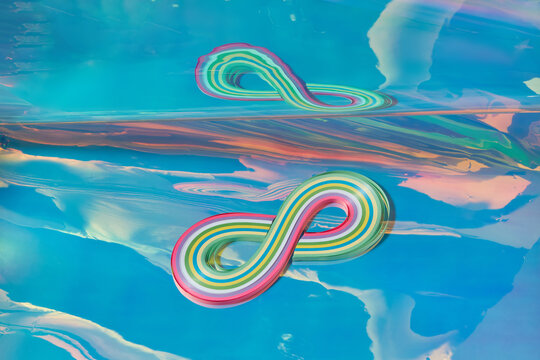 Colourful wavy volumetric figure reflecting in studio