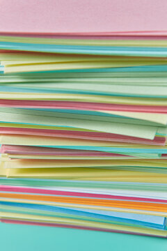 Layers of vibrant colourful papers for origami crafts