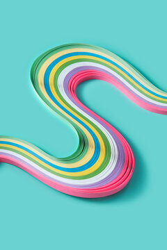 Colourful decorative papers laying in swirls in minty studio
