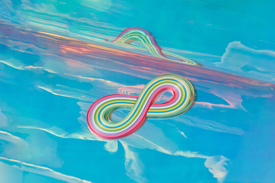 Striped infinity figure in multiple colours over abstract background