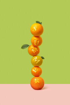 Tower of ripe fruits with leaves with peeled letters on surface