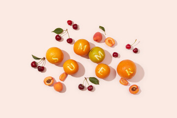 Combination of letters on peel of oranges creating summer word