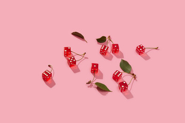 Handful of cherries with playing cubes instead of berries in studio