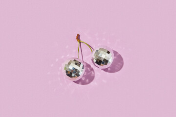 Two silver disco balls in form of berries connected by cheery stem