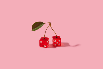 Couple of red dices with white dots connected with berry stems