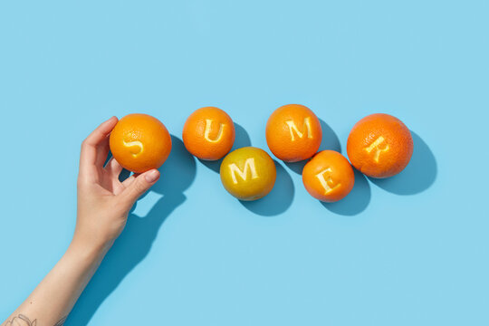 Hand raising orange patterned with s letter on blue background