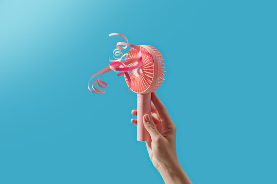 Palm of human holding portable ventilator with attached laces