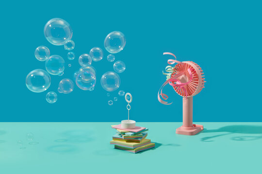 White wand making soap bubbles under influence of blowing fan