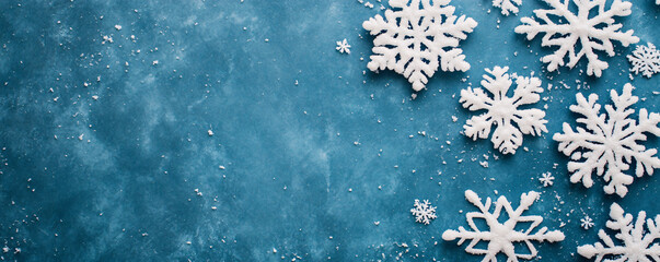 A serene winter scene featuring delicate white snowflakes on a blue background, perfect for holiday-themed designs.