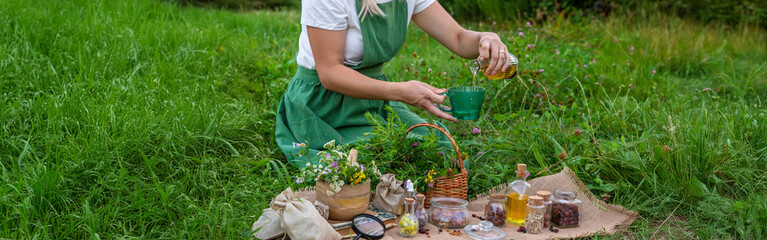 woman and herbal tinctures, tea, medicinal herbs.