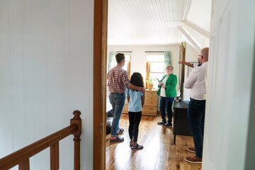 Family Discussing Bedroom Details with Real Estate Agent