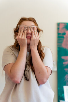 Woman with Eyeglasses and Tired Eyes