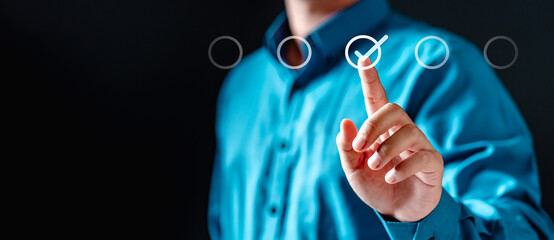 touch, innovation, tech, click, digital, interface, virtual, interaction, contact, diagram. A man is pressing virtual a screen with a check mark on it. Concept of accomplishment or satisfaction.