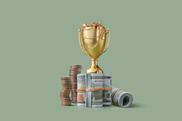 Shiny goblet placed at money rolls and coins tower