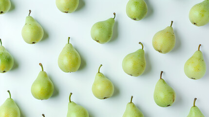 top down view of green pears evenly distributed on white background