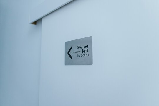 Close up of instruction for opening door of mini-room in capsule hotel