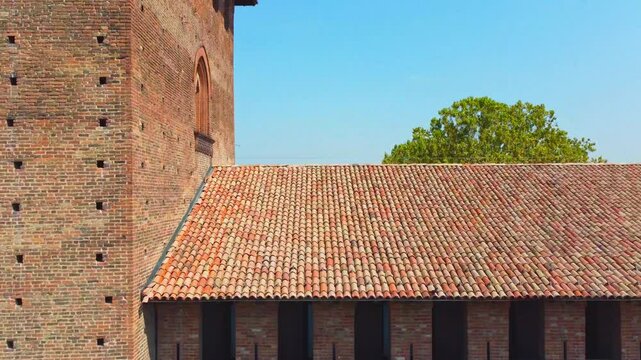 Italian castle an artistic historical cultural heritage. Visconti castle of Pavia with its walls, bridge, moat, towers. Structure that attracts tourists traveling to discover the wonders of Italy.