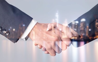 Double exposure of business people handshake and city background