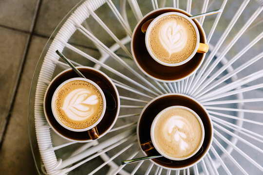 Cups of coffee on table