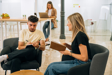 Coworkers discussing project in office