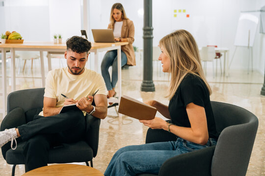 Coworkers discussing project in office