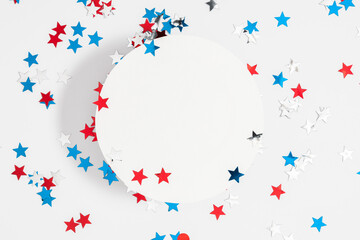 4th of July, USA Presidents Day, Independence Day. Flat lay top view of celebration decor, circle for text twinkling confetti on white background, promotion or greeting message