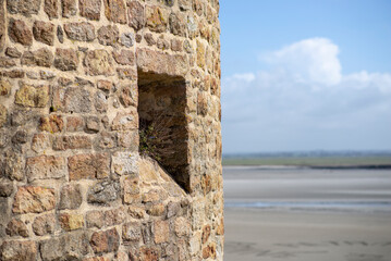 Historic coastal stone structure with scenic beach view