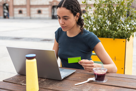 Entrepreneur processing online payment with laptop and credit card