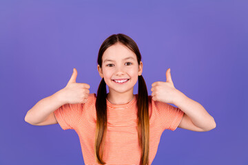 Photo portrait of pretty little girl thumb up approve wear trendy red outfit isolated on purple color background