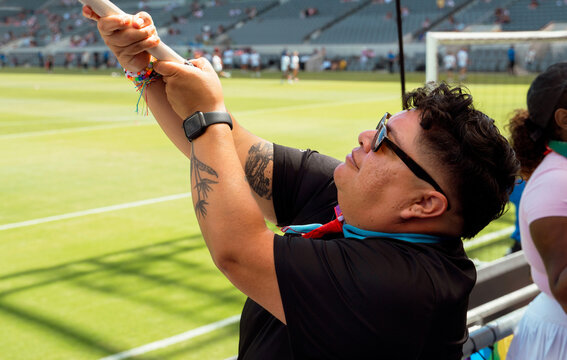 Sports Fan Waves Flag at Game 