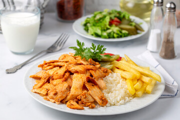 Chicken doner on pilaf with french fries and pickles