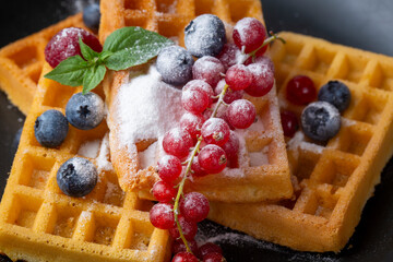 Delicious fresh baked belgian waffles with berries and fruit