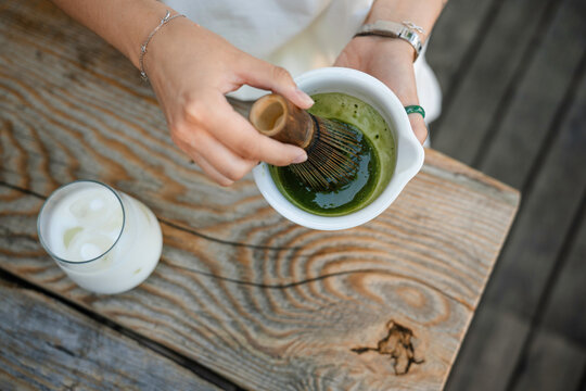 A woman whips up matcha tea