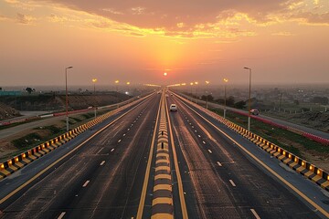 Fototapeta premium A long highway with a sunset in the background