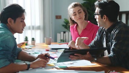 Obraz premium Top view of civil engineer discussing about house construction while planning about building design at meeting table with blueprint and architectural equipment. Design brainstorming idea. Symposium.