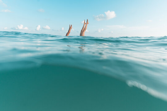 Double handstand in the water with copy space