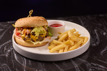 A Delicious Burger served with Crispy Fries and a side of Ketchup on a Dark Marble Table