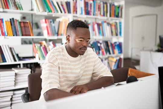 Student studying in bright library