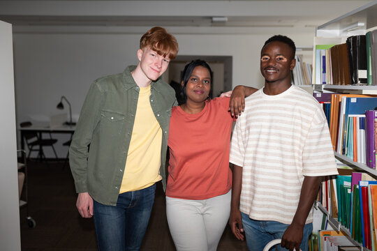 Group of relaxed cheerful friends in library