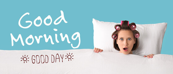 Beautiful young shocked woman in hair curlers with with soft pillow and blanket on blue background