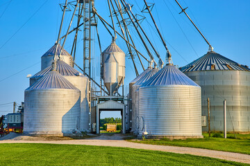Grain Silos and Conveyors in Rural Farm Setting Eye-Level Perspective