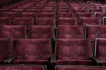 Rows of red seats in a theatre or concert hall