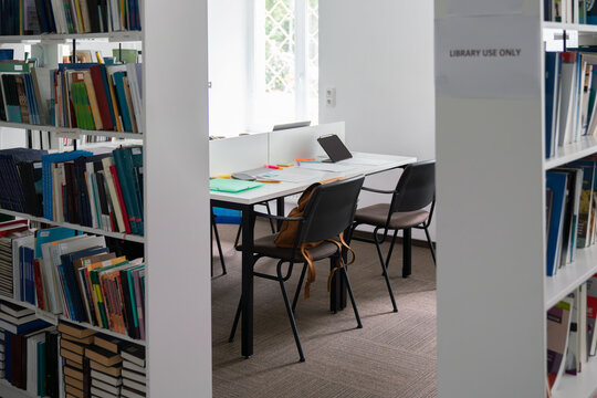 Library study room with bookshelves surrounding table