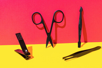 Colorful Background with Manicure Tools - Scissors, Nail Clipper, Cuticle Pusher, and Tweezers