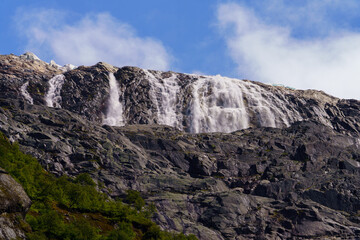 Majestic Glacial Waterfall Cascading Down Rocky Cliffs in the Norwegian Highlands