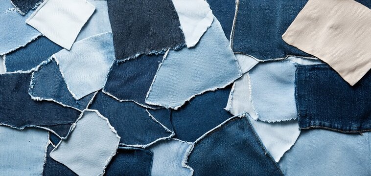Creative mix of torn denim pieces and jean pockets, each with its own unique shade and texture, evoking a sense of recycled fashion