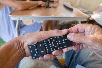 Close-up of a man's hands with domino tiles